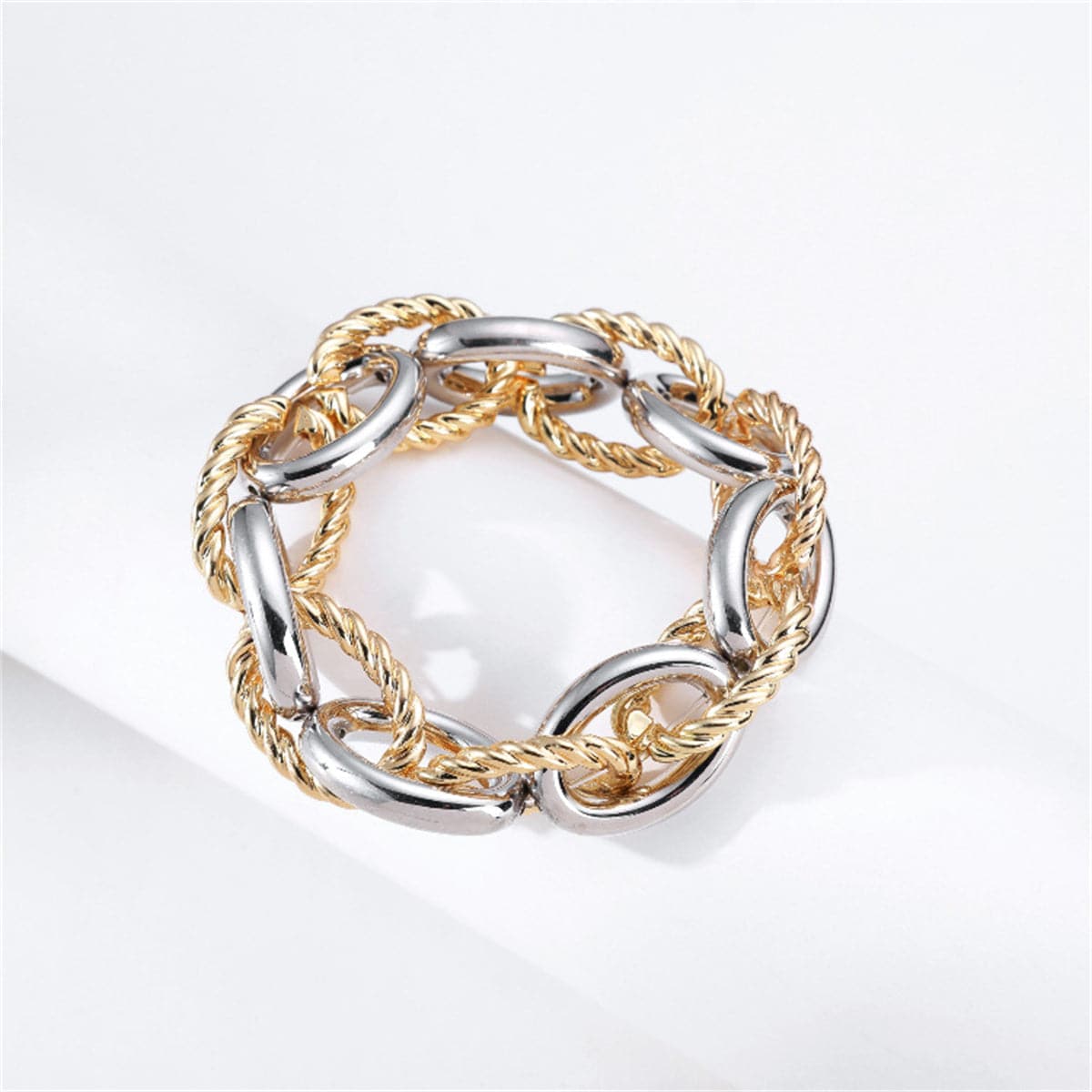 Two-tone bracelet featuring interlocked gold and silver twisted chain links in an oval design.