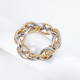 Two-tone bracelet featuring interlocked gold and silver twisted chain links in an oval design.