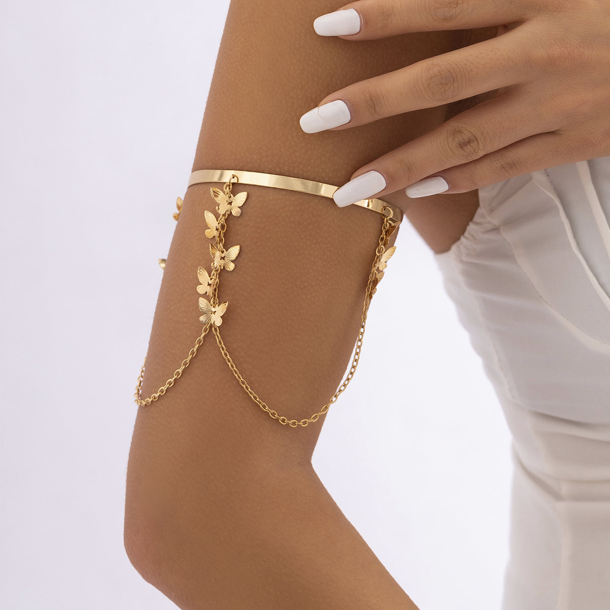 Elegant 18K gold-plated butterfly arm cuff adorned with a stunning gold chain bracelet for a luxurious touch.