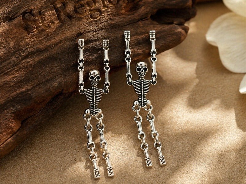 Cover image for Halloween Jewelry Trends: Spooky Earrings Worth Knowing: St.Region Silvertone Skeleton Dangle Earrings in silvertone arranged on a neutral surface.