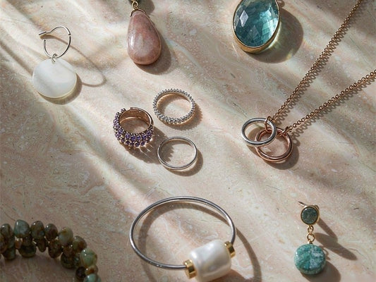 St.Region sustainable jewelry collection - handmade necklaces with gemstones, crystal earrings, stackable rings and pearl bracelet on marble