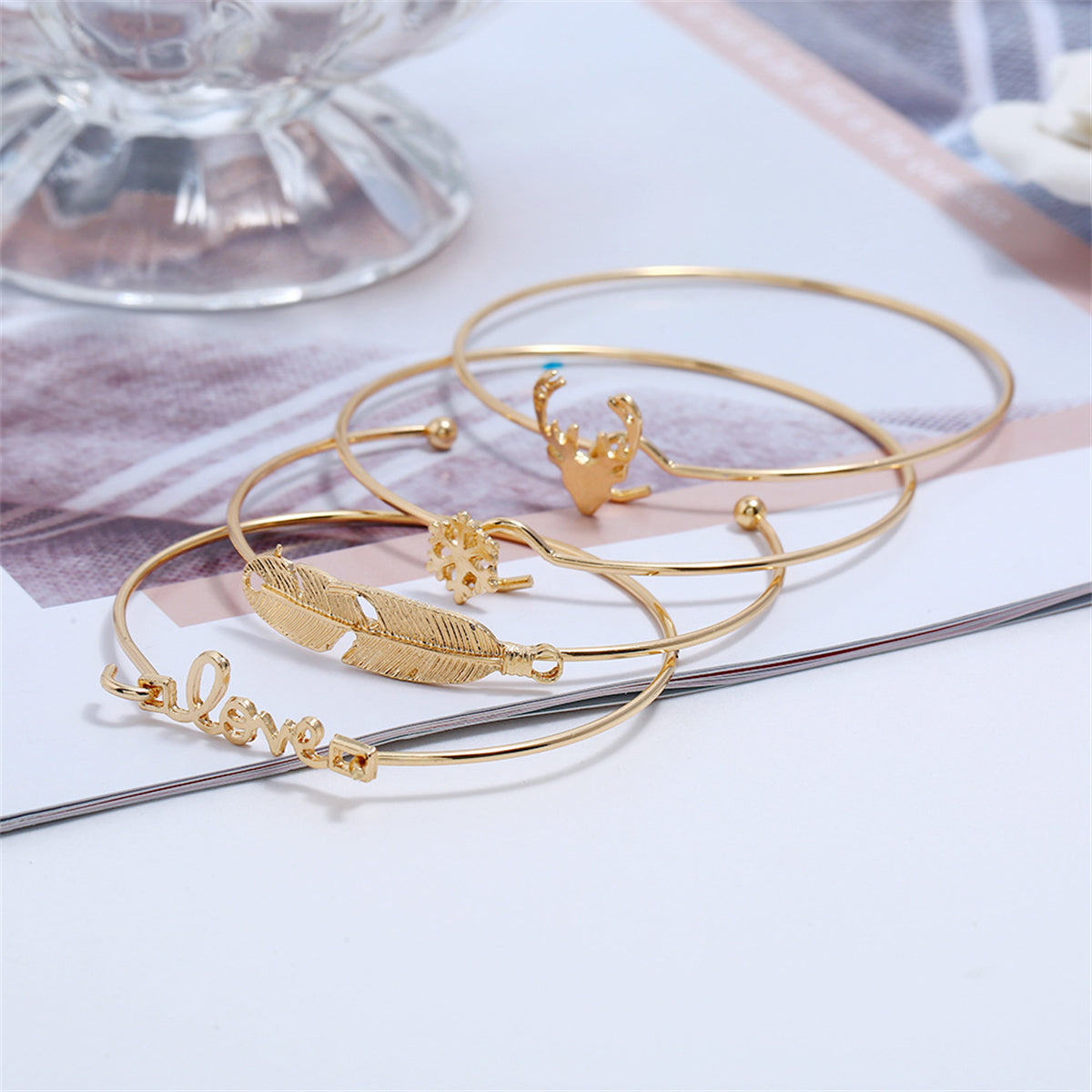 Four distinct gold bangles with intricate designs, a stylish addition to your Christmas jewelry collection.