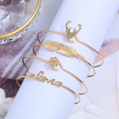 Elegant set of four gold bangles with unique designs, perfect for enhancing your holiday outfits and gift-giving.