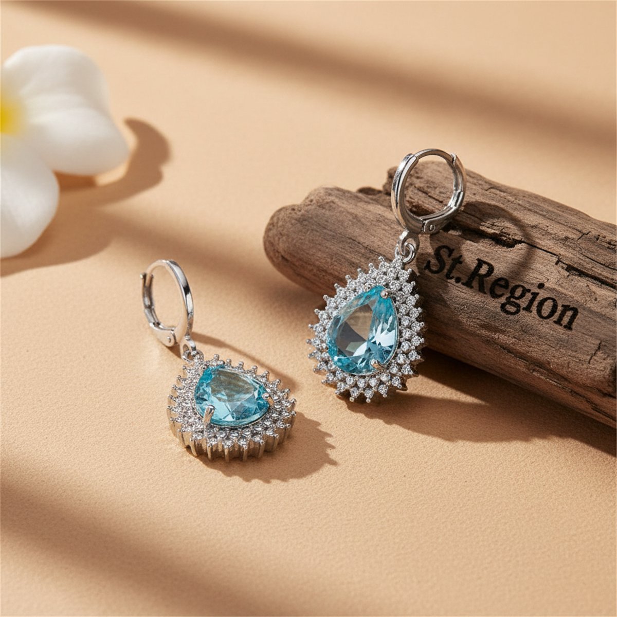 Blue Crystal and Silver-Plated Pear-Cut Halo Drop Earrings, silver huggie earrings, botanical inspired, front view
