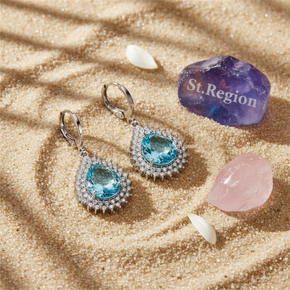 Blue Crystal and Silver-Plated Pear-Cut Halo Drop Earrings, silver huggie earrings, botanical inspired, detail close-up