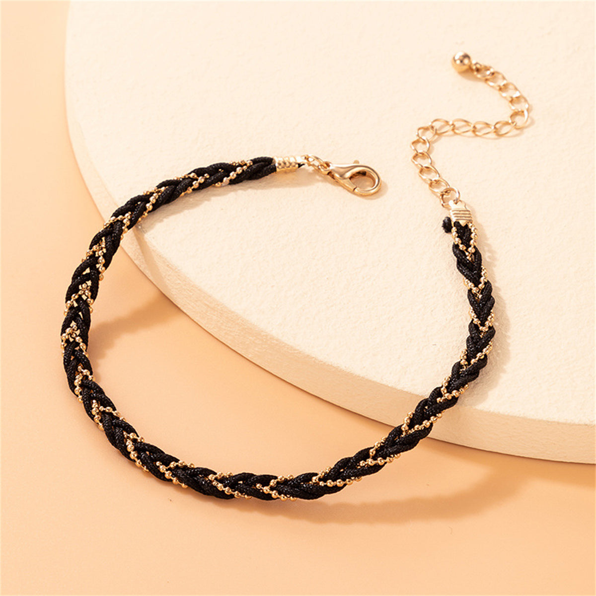 Chic black polyester braided anklet adorned with a stunning 18K gold-plated chain for a touch of luxury.