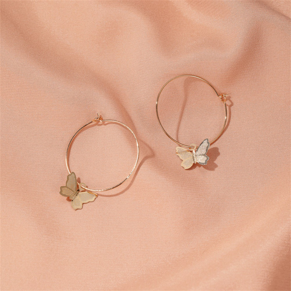 Beautifully crafted 18K gold-plated butterfly huggie earrings, a must-have accessory for a chic and trendy look.