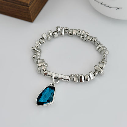 Teal Crystal and Silvertone Beads Irregular Charm Stretch Bracelet, botanical inspired, side view