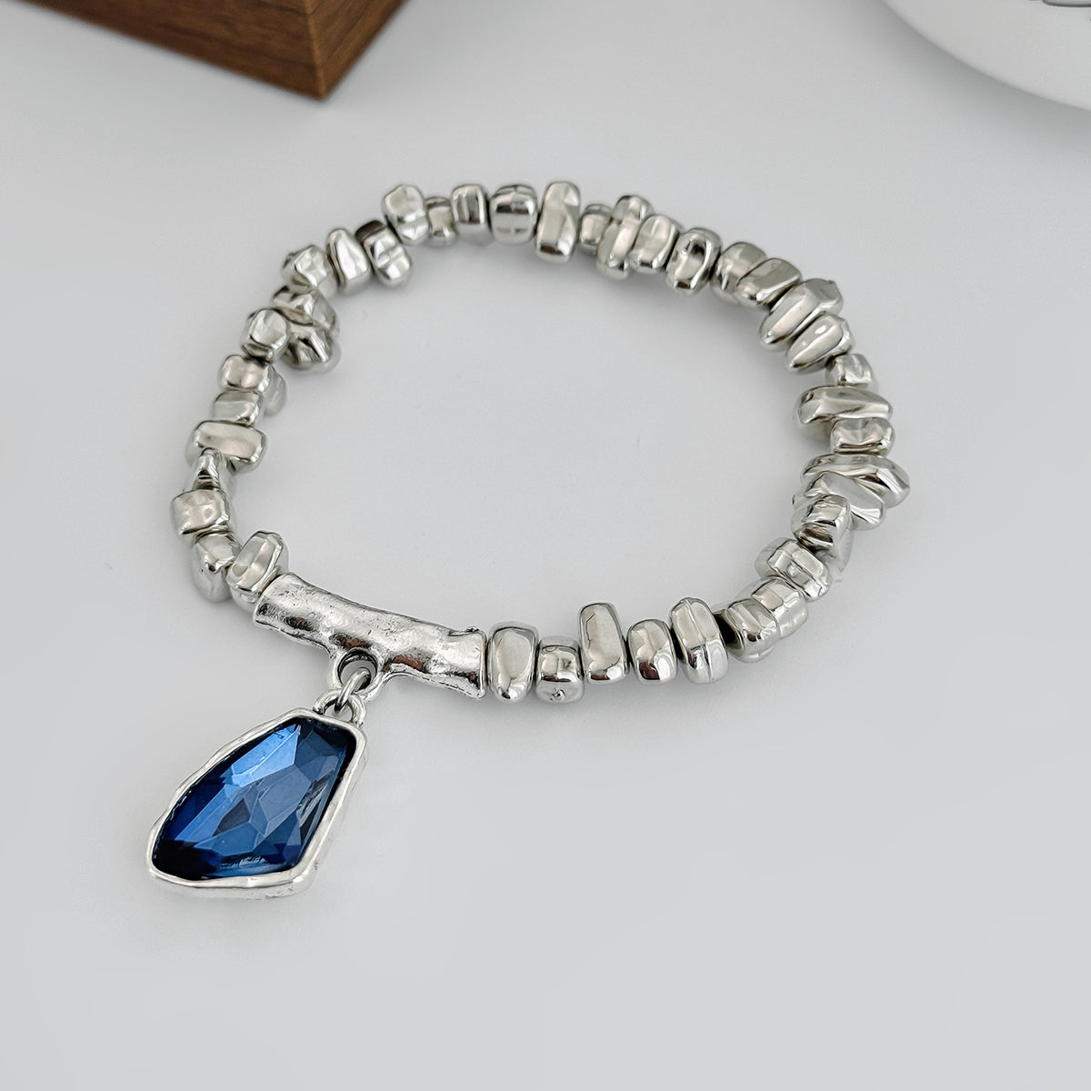 Blue Crystal and Silvertone Beads Irregular Charm Stretch Bracelet, botanical inspired, side view