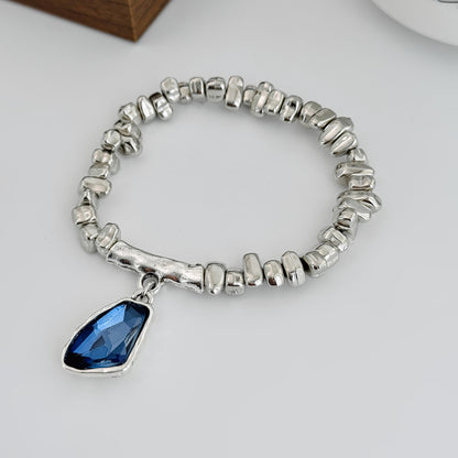 Blue Crystal and Silvertone Beads Irregular Charm Stretch Bracelet, botanical inspired, side view