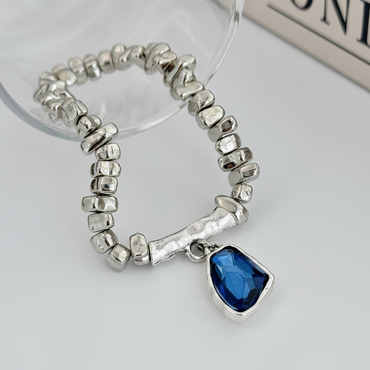 Blue Crystal and Silvertone Beads Irregular Charm Stretch Bracelet, botanical inspired, detail close-up