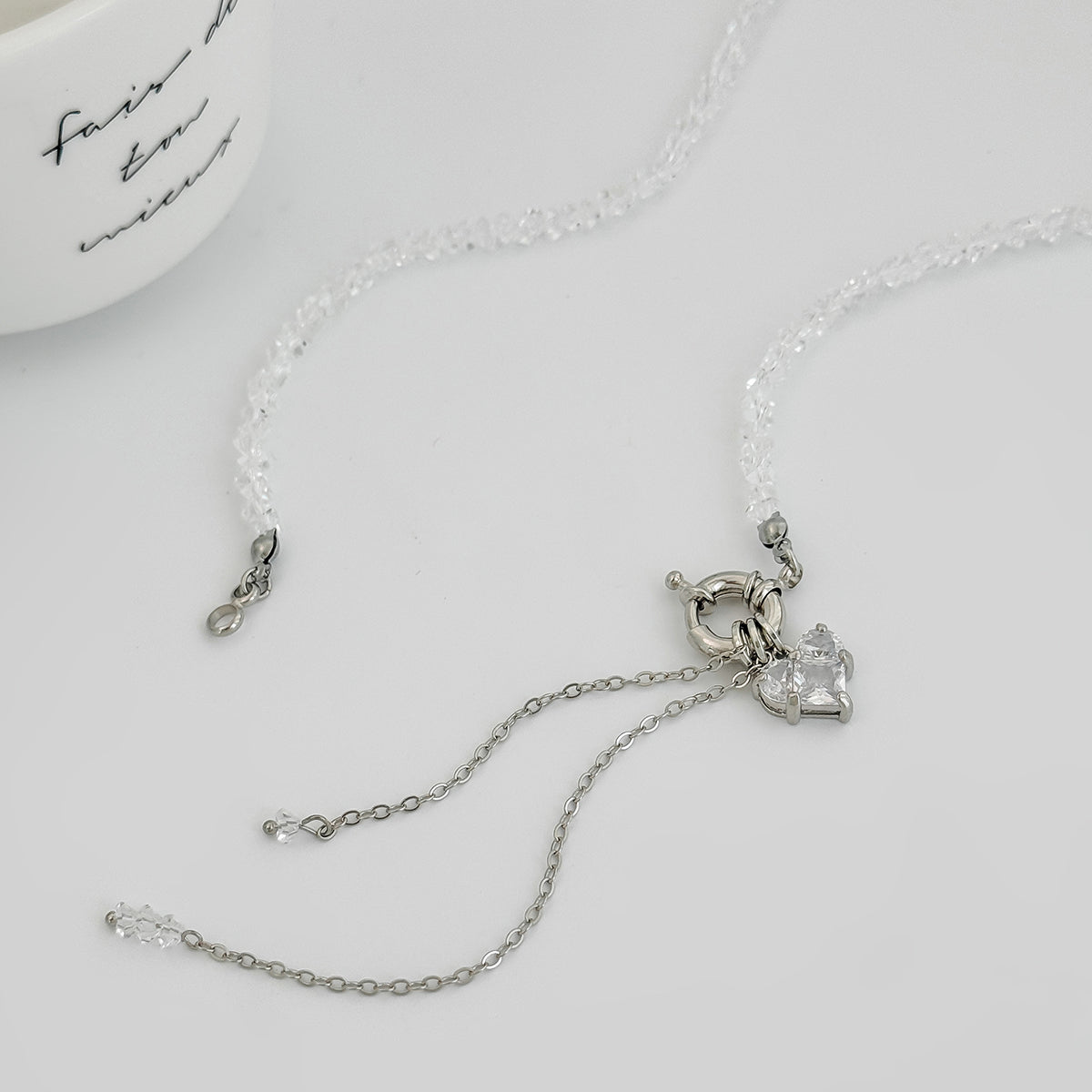 Clear Crystal and Acrylic Silvertone Heart Pendant Tassel Toggle Necklace, vintage-inspired design, detail close-up