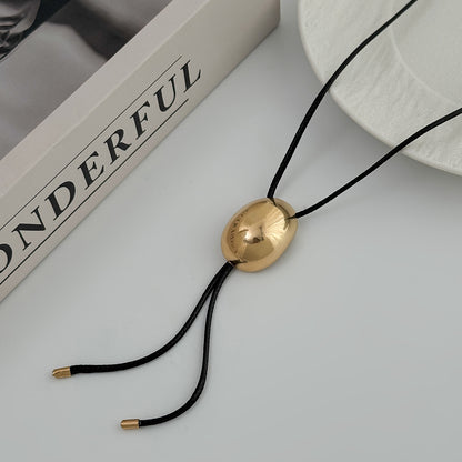 Black Polyster and Goldtone Oval Tassel Necklace, botanical inspired, side view