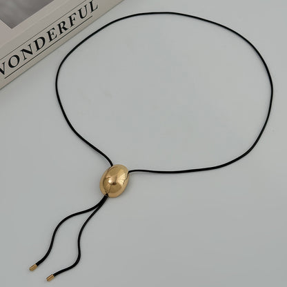 Black Polyster and Goldtone Oval Tassel Necklace, botanical inspired, detail close-up