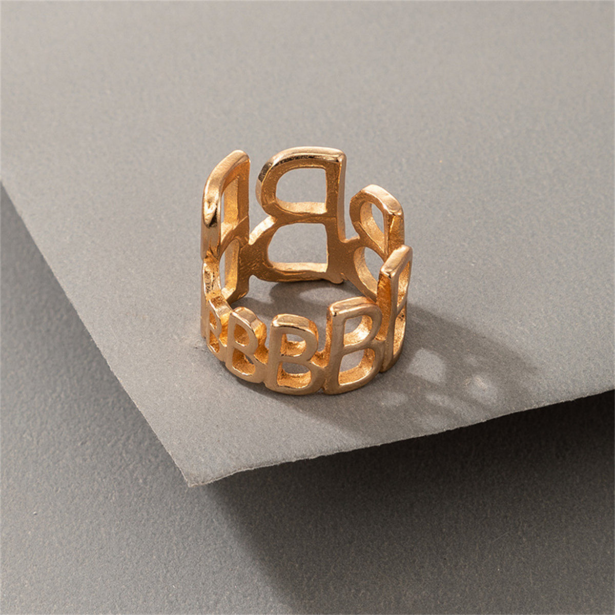 Dazzling 18K gold-plated ring with an intricate openwork design, highlighting the letters 'B', adjustable for all.