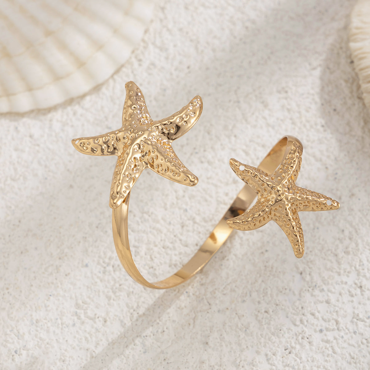 Goldtone Hammered Dual-Starfish Bypass Arm Cuff, dainty minimalist design, detail close-up
