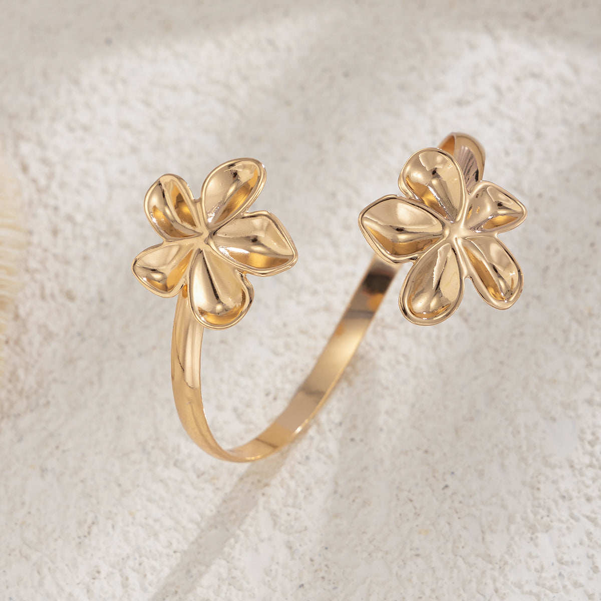 Goldtone Dual-Flower Bypass Arm Cuff, botanical inspired, detail close-up