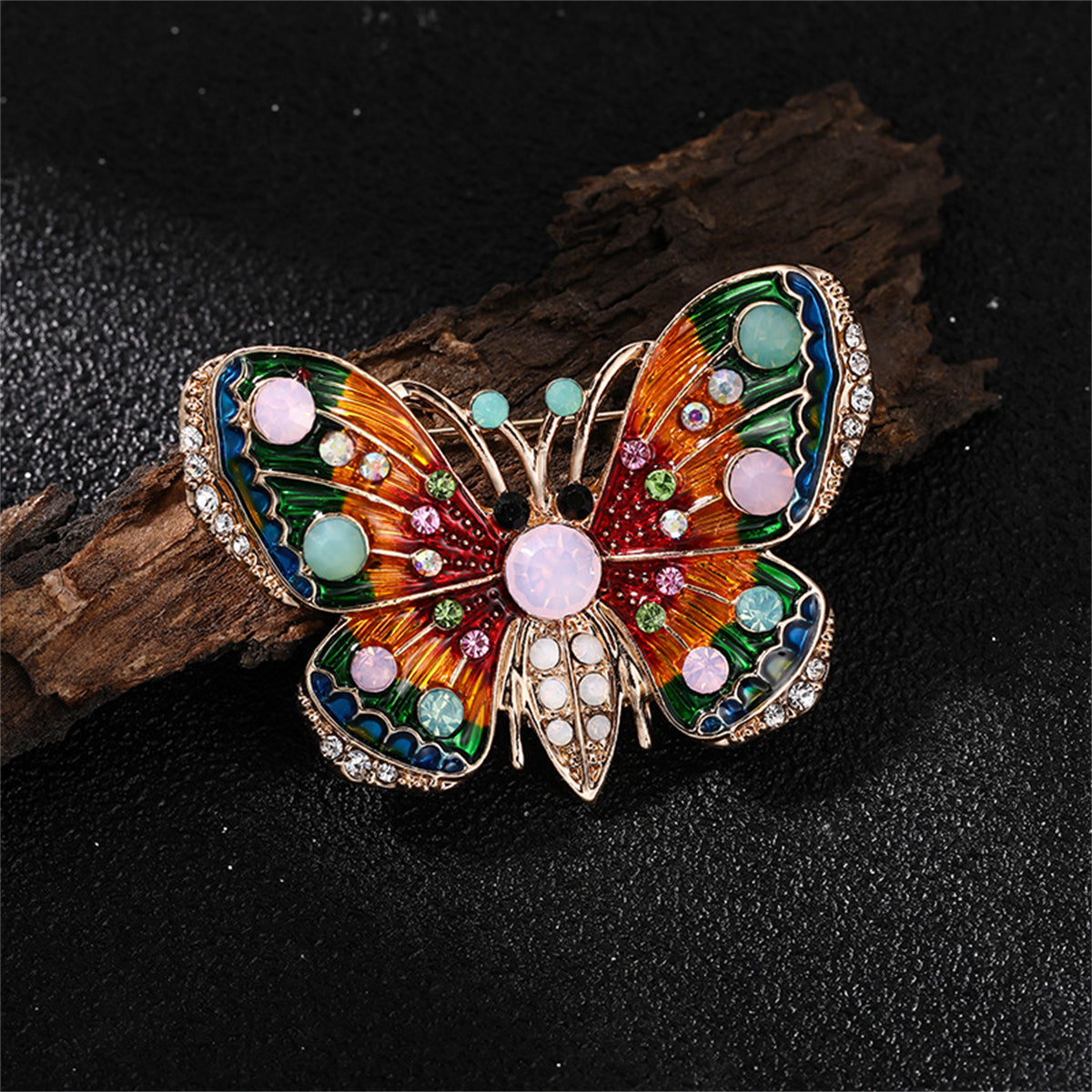 A stunning 18K gold-plated butterfly brooch adorned with vibrant multicolored stones, perfect for adding elegance to any outfit.