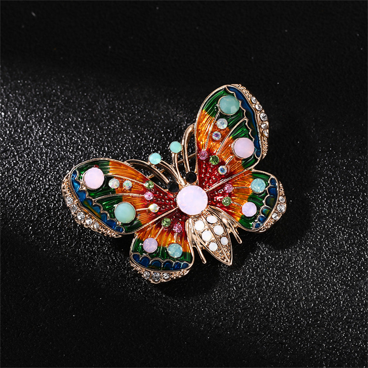 Eye-catching 18K gold-plated butterfly brooch featuring dazzling multicolored stones, a beautiful accessory for any occasion.