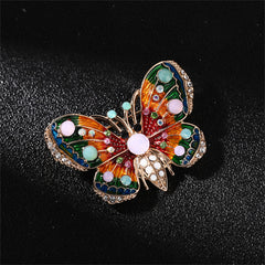 Eye-catching 18K gold-plated butterfly brooch featuring dazzling multicolored stones, a beautiful accessory for any occasion.