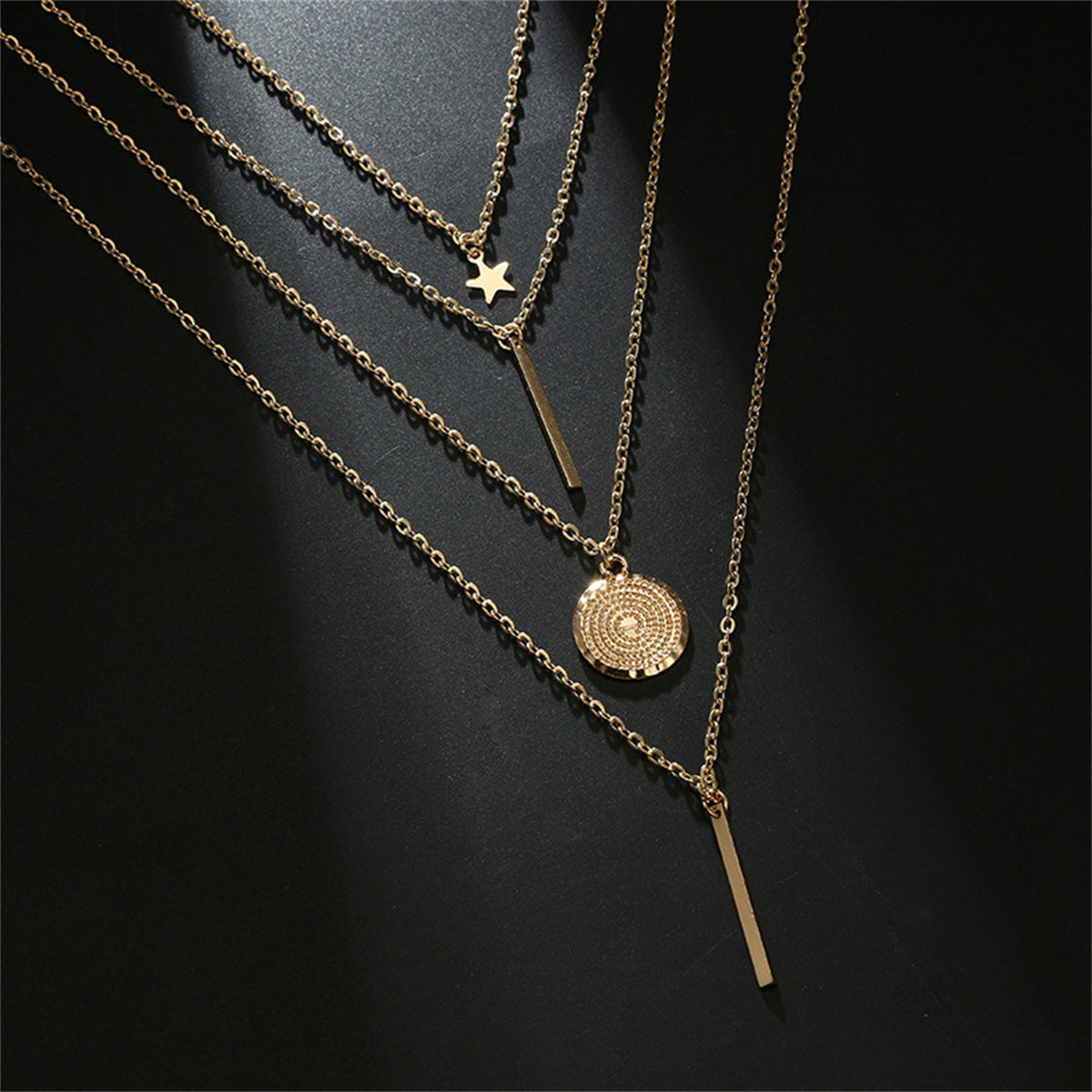 Stunning 18K gold-plated layered necklaces showcasing a star and a coin, perfect for adding elegance to any outfit.