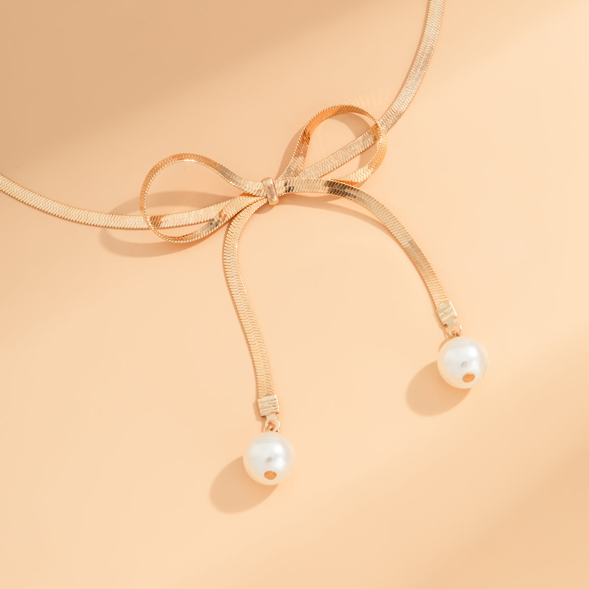 Pearl and 18K Gold-Plated Bow Choker Necklace, gold pendant necklace for women, dainty minimalist design, detail close-up
