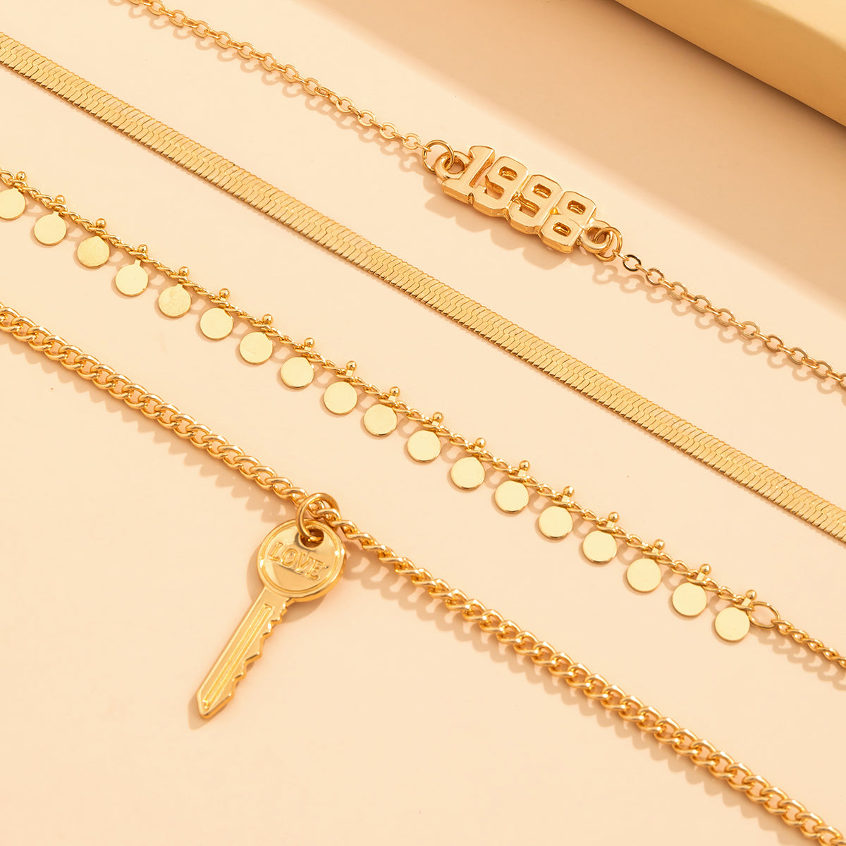Beautiful 18K gold-plated necklace showcasing a layered style and a key charm, ideal for a chic accessory.
