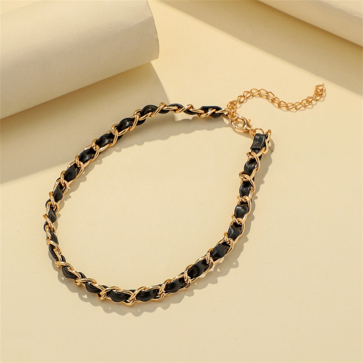 Simple yet stylish black and gold chain choker, crafted with 18K gold-plated accents and a polystyrene cable design.