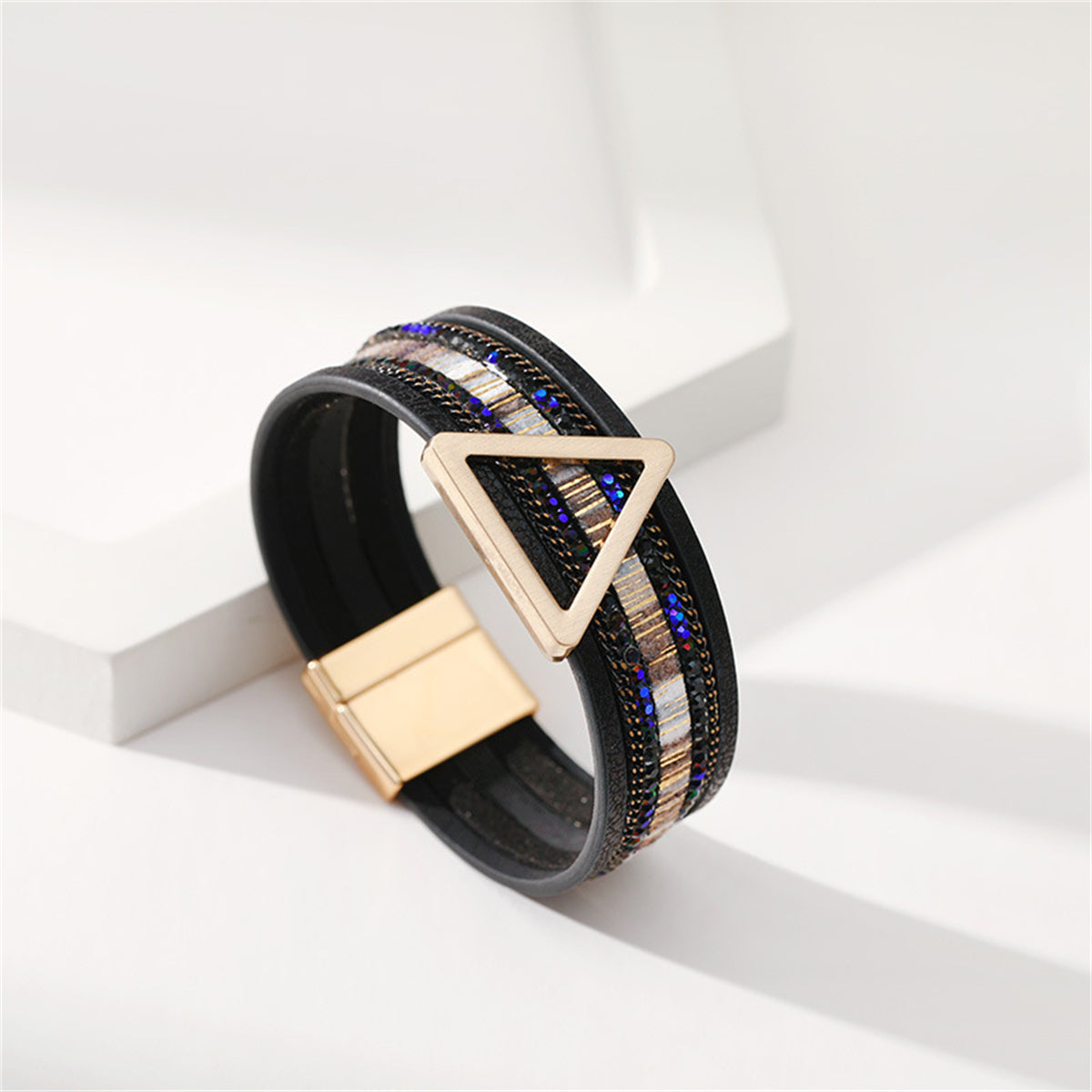 Stylish black leather bracelet showcasing a triangle design, complemented by a luxurious 18K gold-plated clasp.