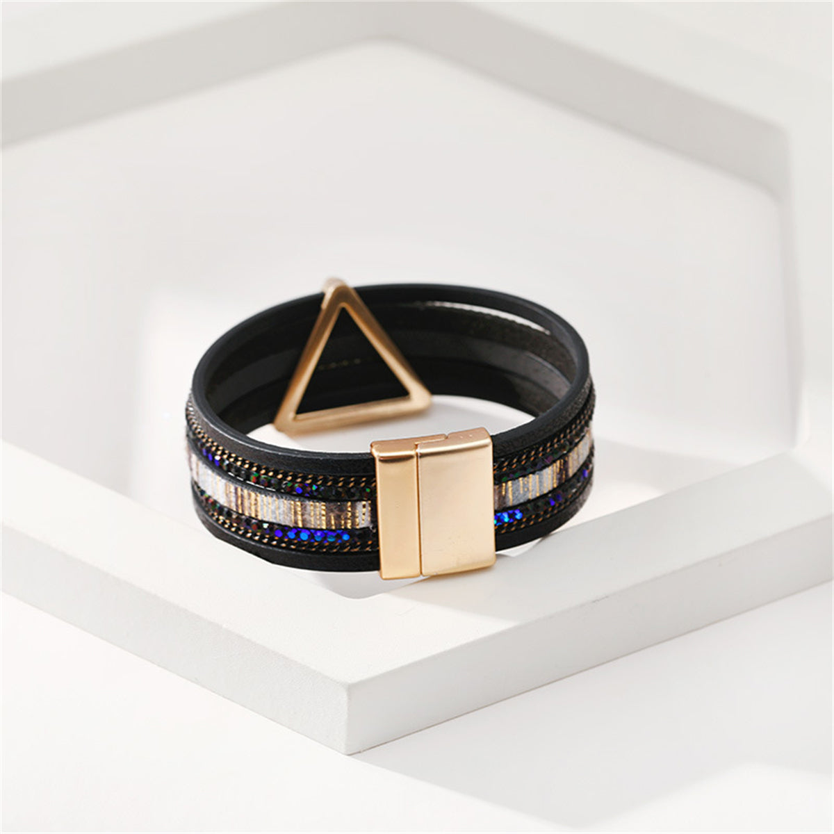 Fashionable black leather bracelet adorned with a triangle pattern and an 18K gold-plated clasp, ideal for modern style.