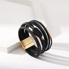 Chic black leather bracelet with eye-catching 18K gold-plated details, adding a touch of elegance to your accessory collection.