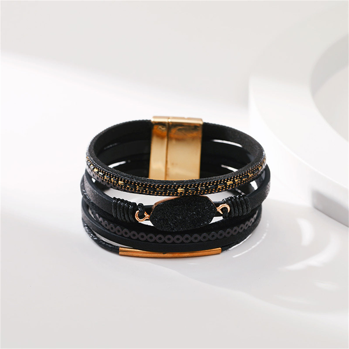 Stylish black leather bracelet adorned with luxurious 18K gold-plated accents, perfect for any outfit.