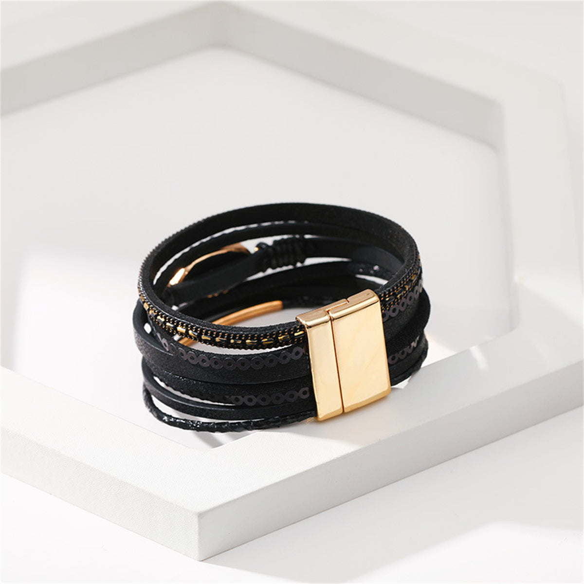 Sleek black leather bracelet with exquisite 18K gold-plated accents, combining modern design with timeless elegance.