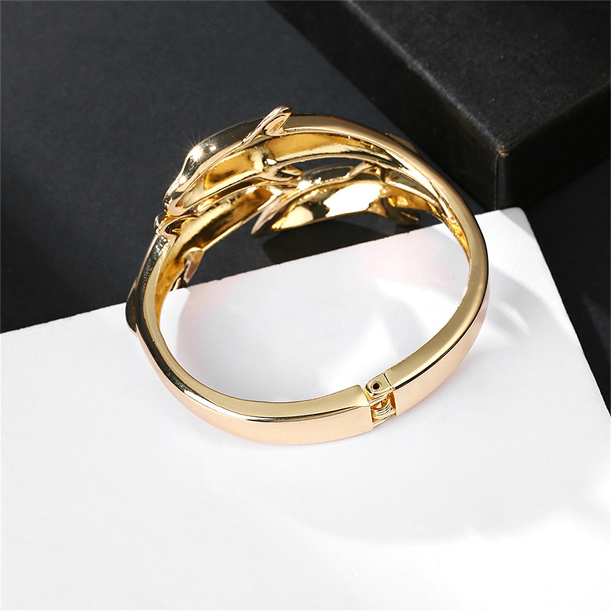 A stunning 18K gold-plated tri-dolphin bangle, featuring a graceful bypass design that enhances its beauty.