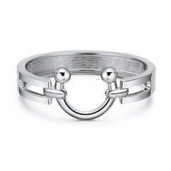 A silver-plated saddle bangle featuring a ring design with two decorative balls on either side.