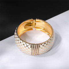 A chic white snake skin bracelet with gold accents, detailed with apricot enamel and cubic zirconia, made of 18K gold plating.