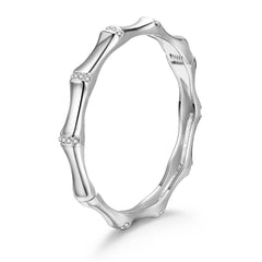 A white gold band adorned with side diamonds, complemented by a cubic zirconia and silver-plated bamboo bangle.