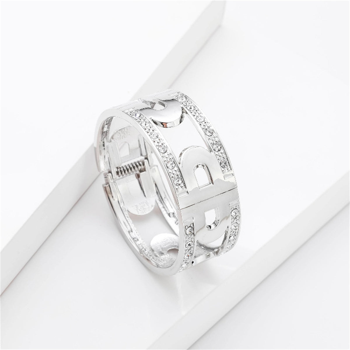 Elegant silver-plated bangle featuring diamonds on the sides, alongside a cubic zirconia and silver-plated lock bangle.