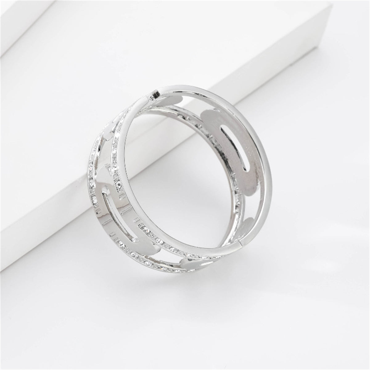 A refined silver-plated bangle with diamonds on the sides, together with a cubic zirconia and silver-plated lock bangle.