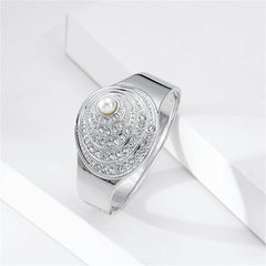 Silver bangle showcasing a pearl and diamond design, paired with a cubic zirconia and pearl silver-plated shell bangle.