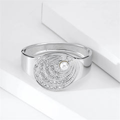 A sophisticated silver bangle with a pearl and diamond design, accompanied by a cubic zirconia and pearl silver-plated shell bangle.