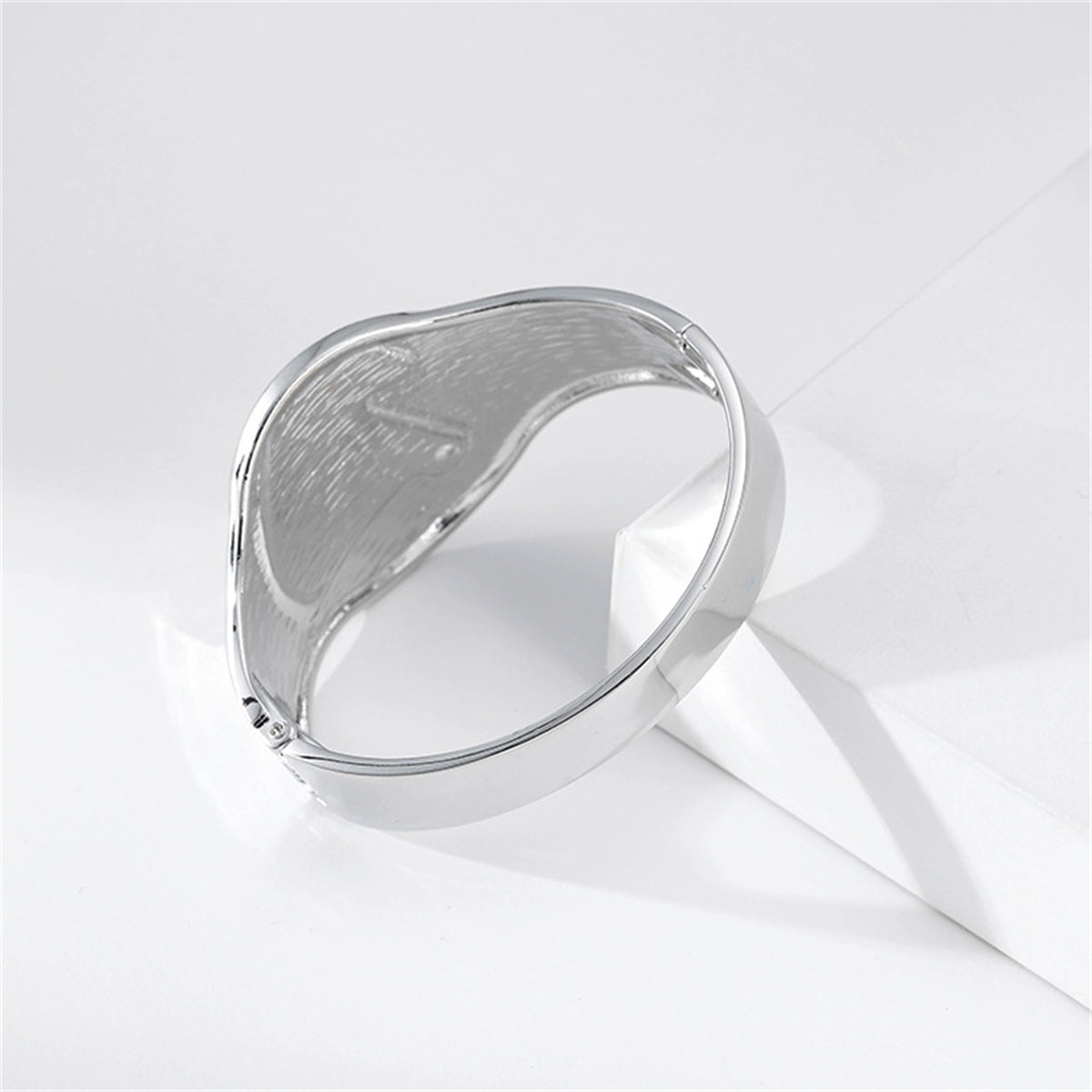 Silver bangle with a pearl and diamond design, enhanced by a cubic zirconia and pearl silver-plated shell bangle.