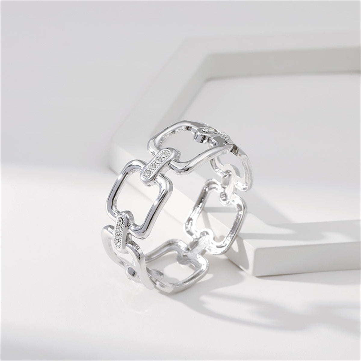 A sophisticated silver-plated and diamond bracelet, showcasing a cubic zirconia and silver-plated open square bangle.