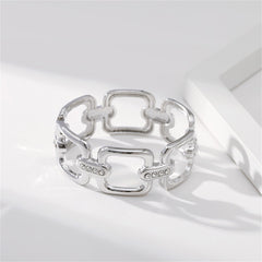 A refined silver-plated and diamond bracelet, incorporating a cubic zirconia and silver-plated open square bangle element.