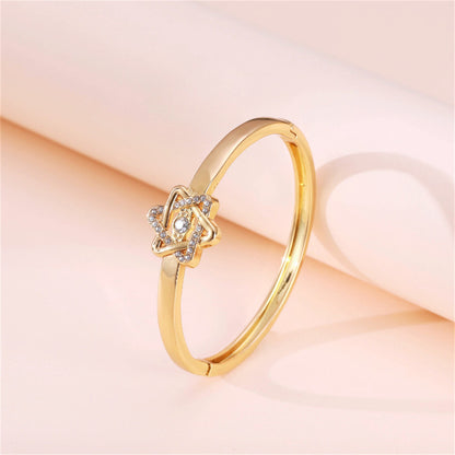Cubic Zirconia and 18K Gold-Plated Flush-Set Openwork Star Hinge Bangle, gold bangle bracelet, detail close-up