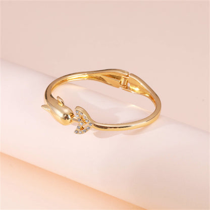 Cubic Zirconia and 18K Gold-Plated Openwork Dolphin Hinge Bangle, gold bangle bracelet, botanical inspired, detail close-up