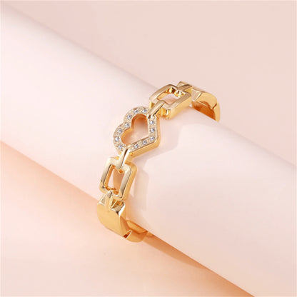 Cubic Zirconia and 18K Gold-Plated Heart Charm Bangle, gold bangle bracelet, botanical inspired, detail close-up