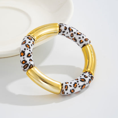 White Resin and Goldtone Cow Print Joint Stretch Bracelet, botanical inspired, lifestyle look