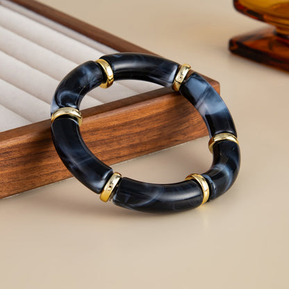 Black Resin and Goldtone Sequin Joint Stretch Bracelet, botanical inspired, side view
