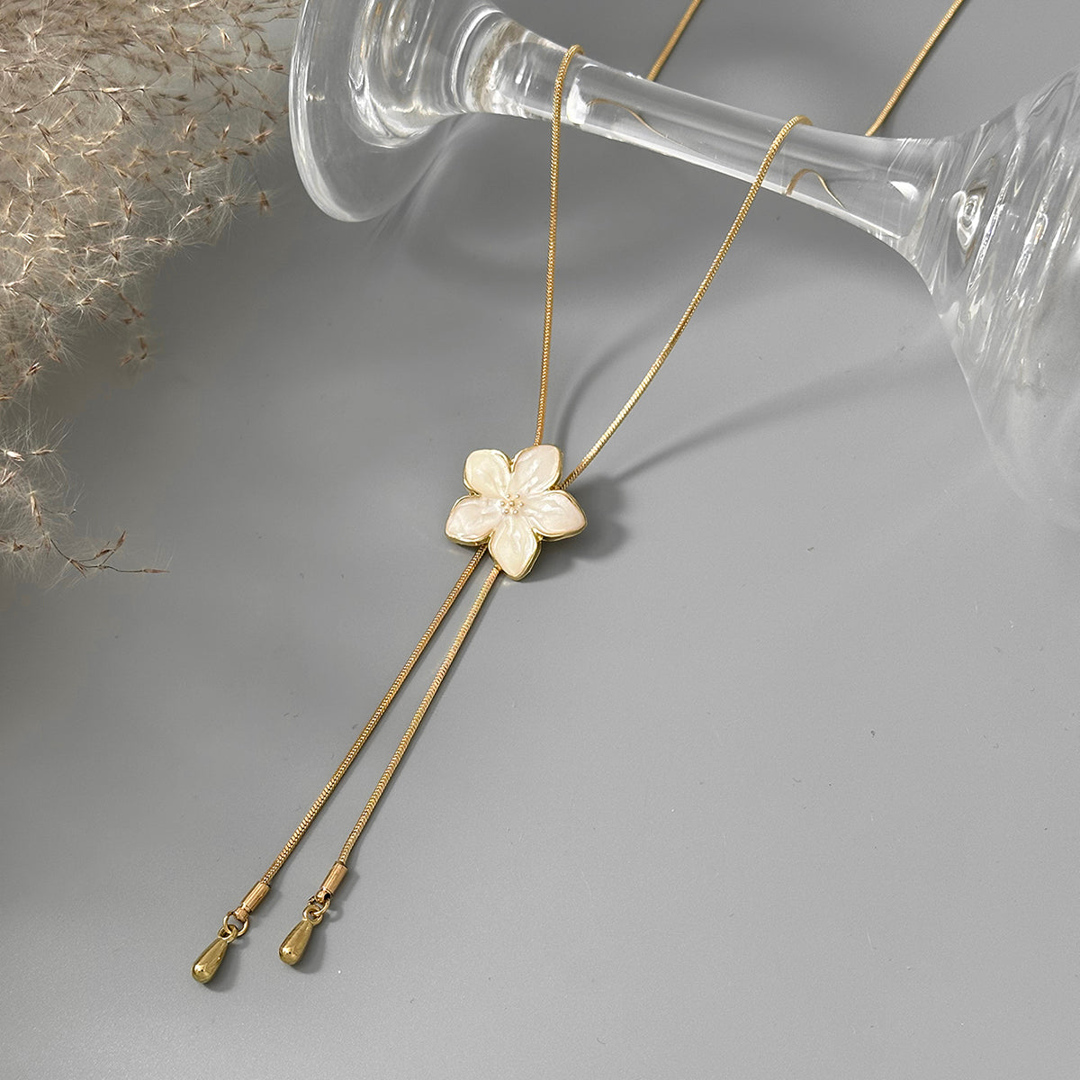 White Enamel and Goldtone Flower Tassel Pendant Necklace, botanical inspired, detail close-up